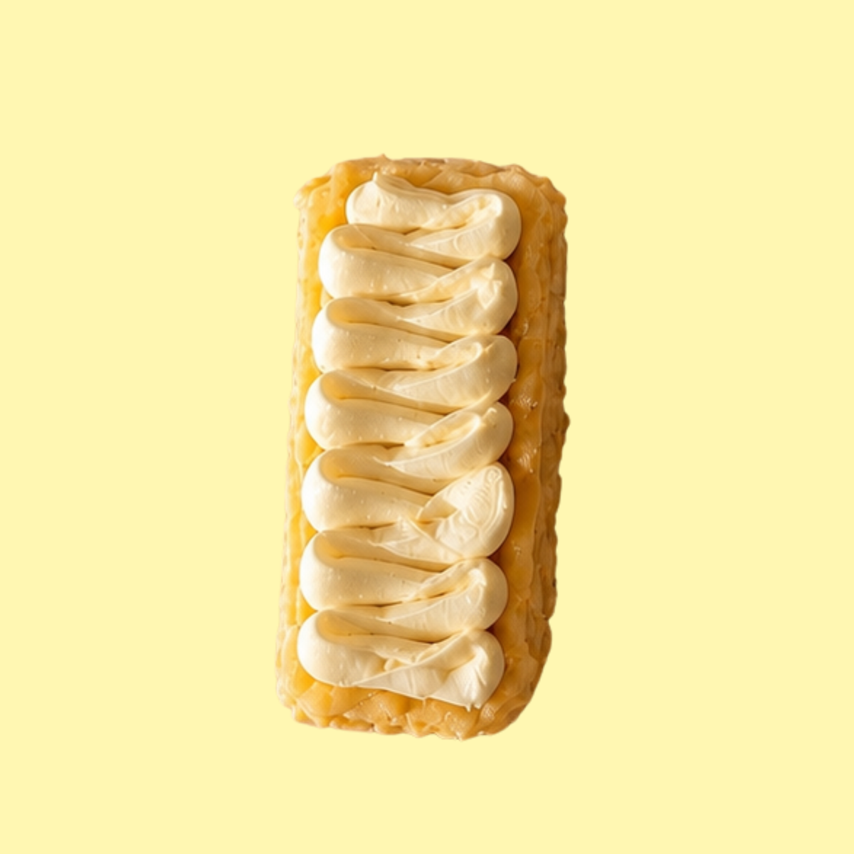 A single rectangular basque cheesecake topped with white cream topping on a pale yellow background. 